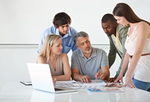 Five colleagues working on an exciting project together on a lap